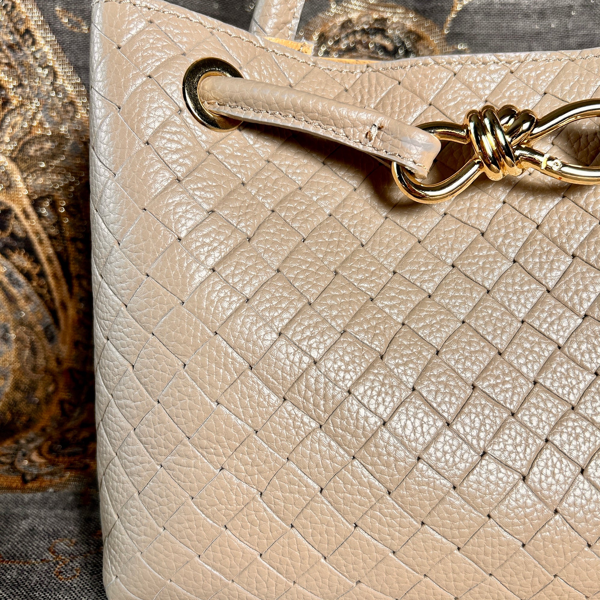 VINCENZA woven leather handbag with gold knot design