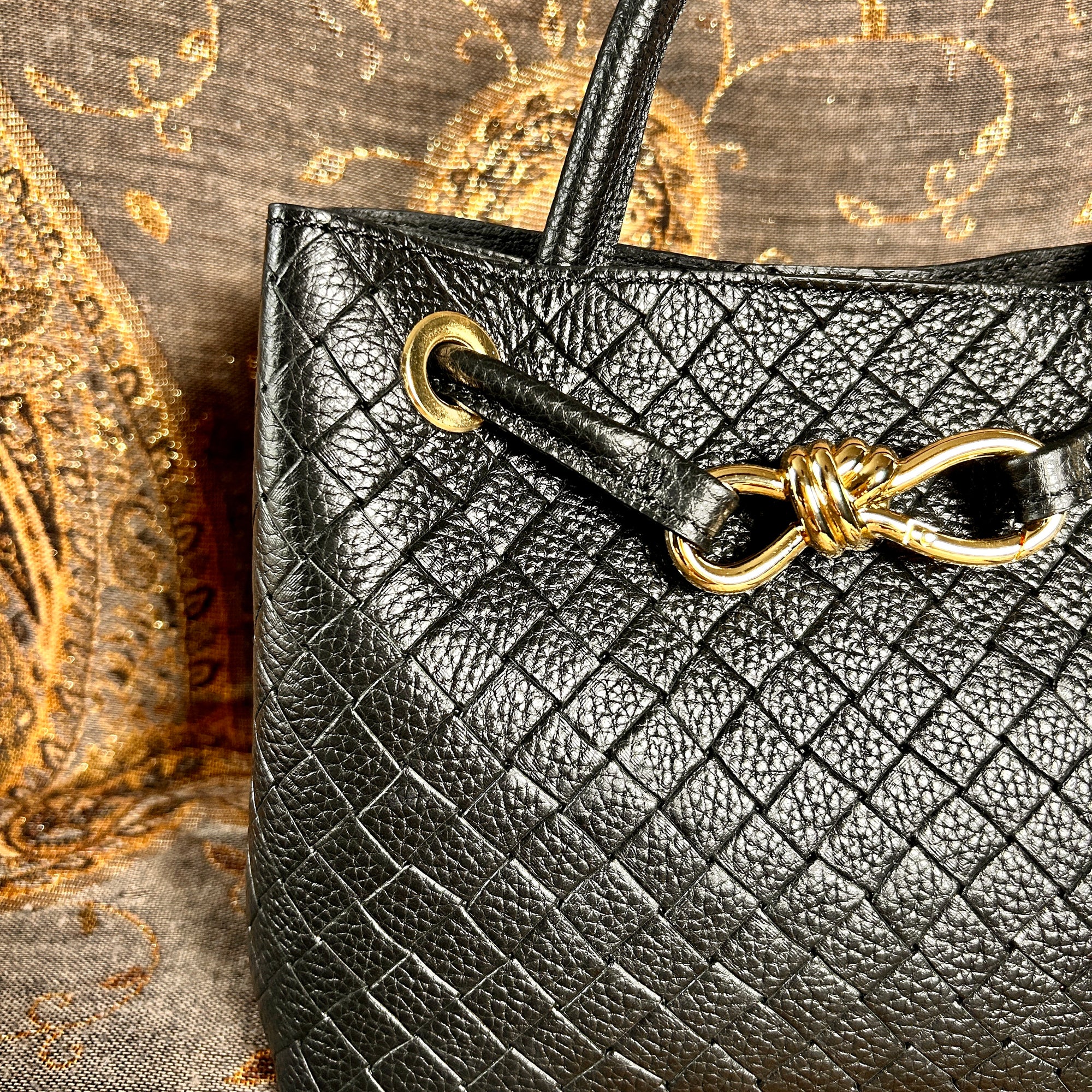 VINCENZA woven leather handbag with gold knot design
