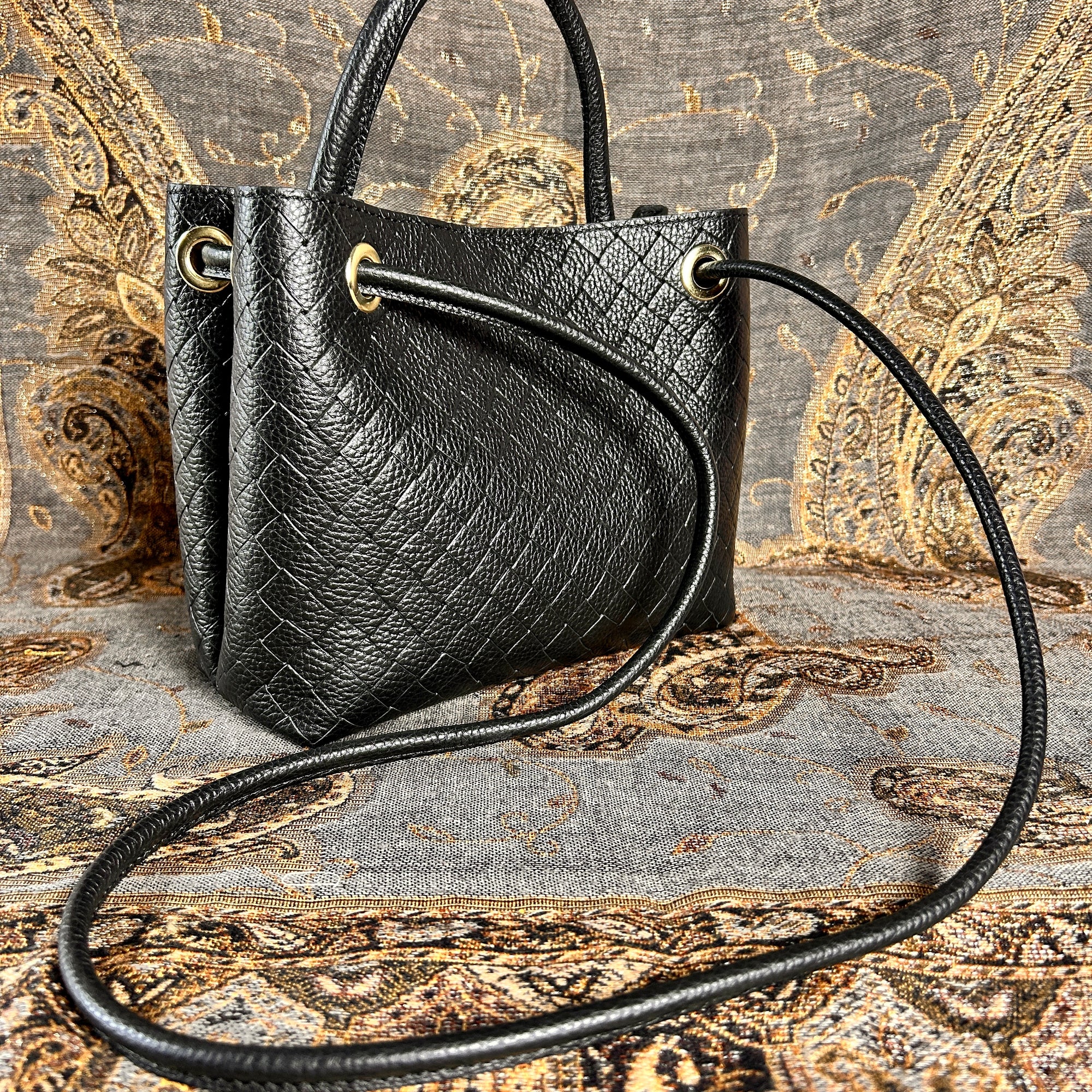 VINCENZA woven leather handbag with gold knot design