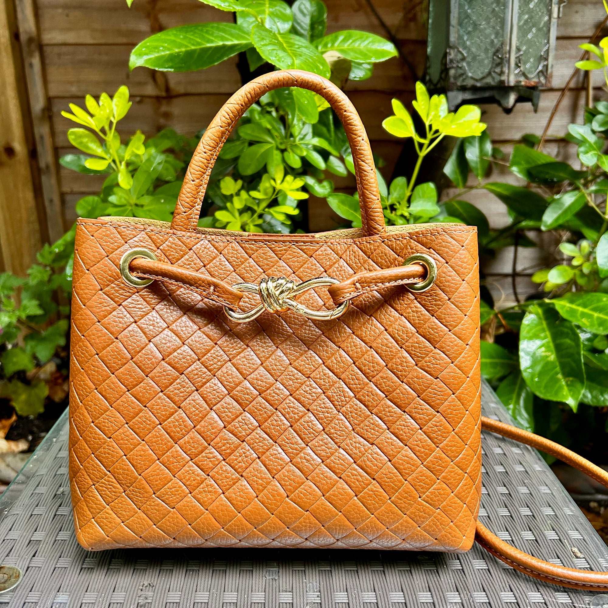 VINCENZA woven leather handbag with gold knot design