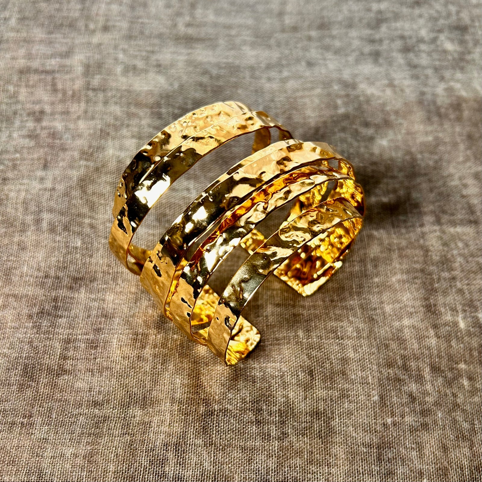 Gold bracelet on a textured gray background